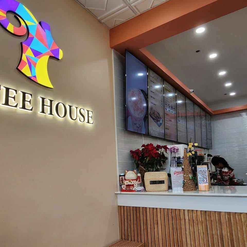 BB Tree House restaurant interior featuring a colorful horse logo, illuminated signage, counter, menu boards, and staff.